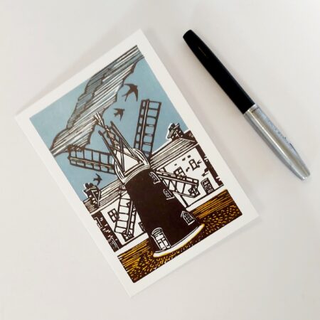 A greeting card showing a lino print of Ellis Windmill with a fountain pen in the forground