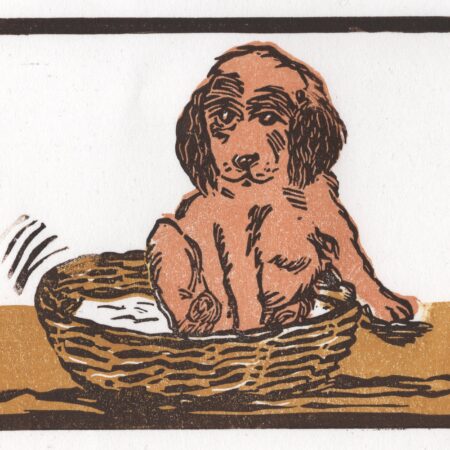 Multi block lino print of a puppy in a basket by Dehlia Barnard-Edmunds aka The Merryweather Artist
