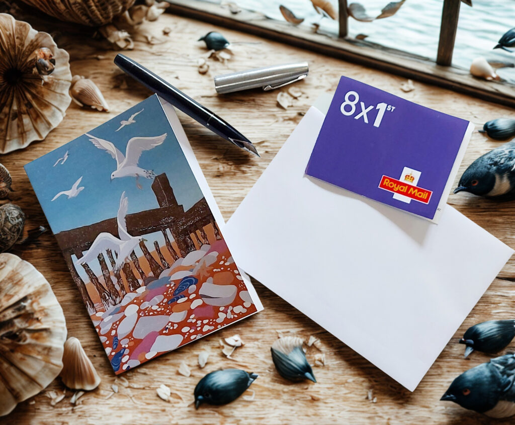 ea Fayre coastal greeting card reproduced from an original reduction lino print featuring seagulls, a seaside harbour and colourful rocks by Dehlia Barnard-Edmunds aka The merryweather Artist